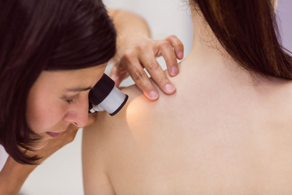 dermatologist examining skin